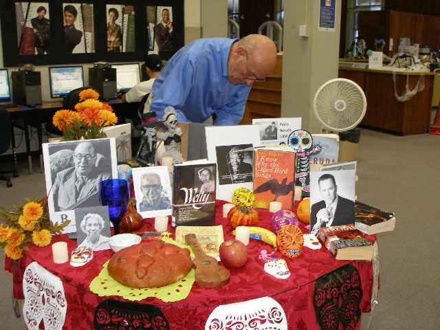 Photo Dia de los Muertos altar -- Francisco putting on finishing touches